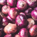 red onion on brown wooden table